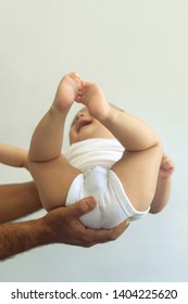 Dad Holding 6-month-old Baby Boy Against The White Background. Father Picking Up His Baby. Free Space. Family Concept