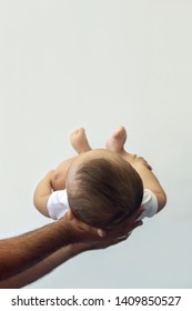 Dad Holding 6-month-old Baby Boy Against The White Background. Father Picking Up His Baby. Free Space. Family Concept