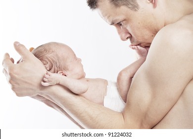 Dad Holding Baby And Kissing Its Feet