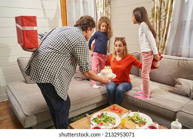 Dad Holding Gift Behind Back And Preparing To Give It