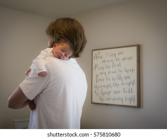 Dad Holding Newborn Baby