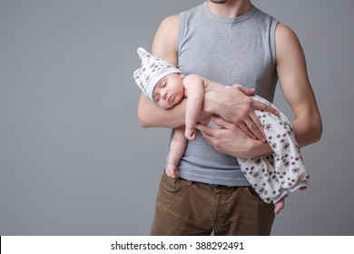 Dad Holding A Small Child. Newborn Baby Sleeping