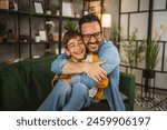 Dad hug son caucasian and share love with him spend time together at home bonding happy together