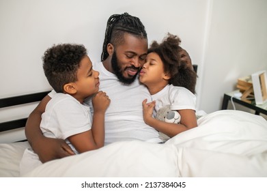 Dad Hugging Son And Daughter Kissing