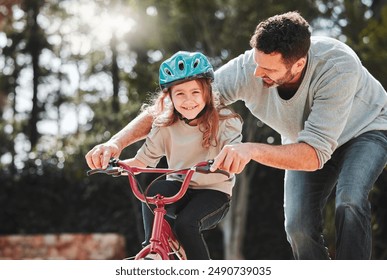 Dad, little girl and learning with ride on bicycle for teaching, lesson or practice at outdoor park. Happy father, daughter or child with smile on bike for bonding, training or cycling in nature - Powered by Shutterstock