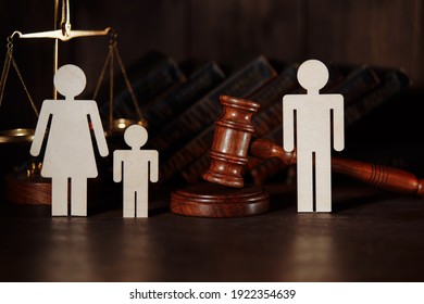 Dad and mom with child figures with judge gavel. Divorce concept - Shutterstock ID 1922354639