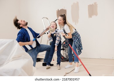 Dad, Mom And Daughter Organized A Concert For The Purchase Of A New Apartment And Renovations In It. Instead Of Real Tools, Paint Rollers And Brushes Are Used.