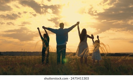 Dad mom son daughter together, nature. Happy family walks on green grass in meadow in spring. Parents, children are walking in park at sunset. Family, child, walk through summer field holding hands. - Powered by Shutterstock