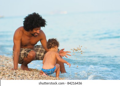 Dad Playing With Baby Daughter, Her First Summer On The Beach