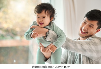 Dad Plays Like A Kid And Protects Like A Bodyguard. Shot Of A Young Man Bonding With His Baby At Home.