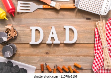 Dad Sign For Father's Day With Grilling Tools On Wood Background.