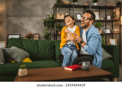 Dad and son caucasian take a break from read teasing each other and have fun at home - Powered by Shutterstock