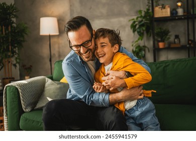 Dad and son caucasian tickle and have fun at home bonding happy together - Powered by Shutterstock