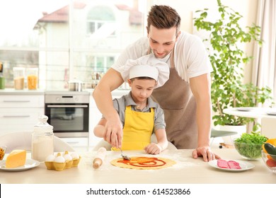 Dad And Son Cooking At Home