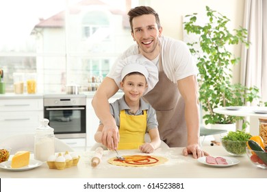 Dad And Son Cooking At Home