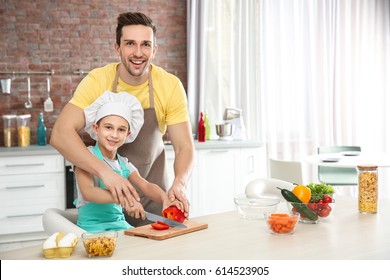 Dad And Son Cooking At Home