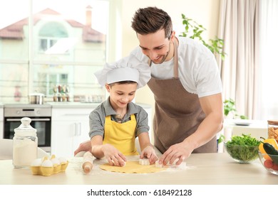 Dad And Son Cooking At Home