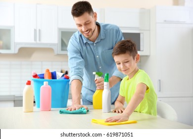 Dad And Son Doing Cleaning At Home