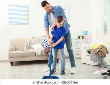 Dad and son doing the cleaning at home - Powered by Shutterstock