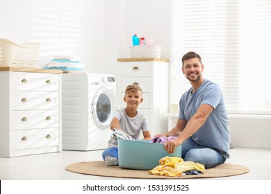 Dad And Son Doing Laundry At Home