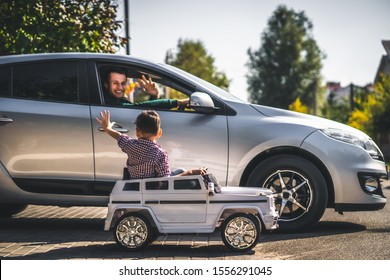 The Dad And Son Driving Their Cars