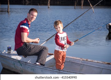 Dad And Son Fishing From A Boat