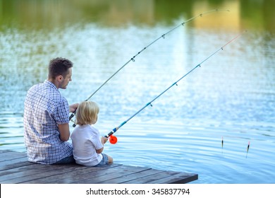 Dad And Son Fishing At Lake