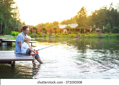 Dad And Son Fishing On Lake