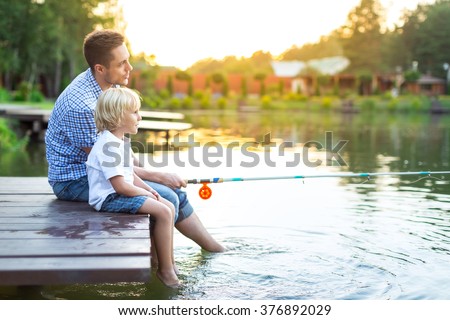 Dad and son fishing on lake