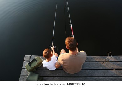 Dad and son fishing together at lake, above view - Powered by Shutterstock