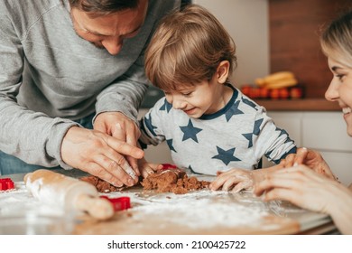 Dad, Son And Mom Are Busy Making Cookie Dough In Kitchen At Home. Family Have Fun Together, Hobby, Teamwork. Happy People. Cooking At Home. Teamwork