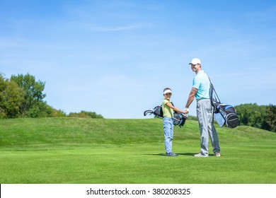 Dad And Son On Golf Lawn