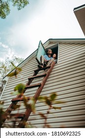 Dad And Son Sit Up The High Stairs To The Attic Of The White Sandwich Panels House And Admire The View From Above. Country Life, Country House Care, Selective Focus