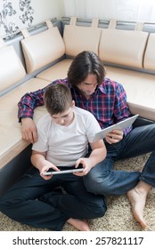 dad and son  with tablet computer indoors