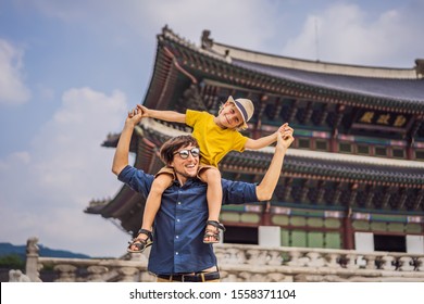 Dad And Son Tourists In Korea. Korean Palace Grounds In Seoul, South Korea. Travel To Korea Concept. Traveling With Children Concept