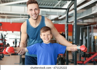 Dad and son training in gym