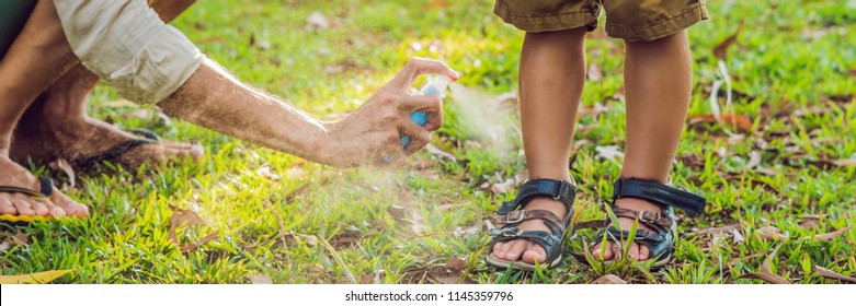 Dad And Son Use Mosquito Spray.Spraying Insect Repellent On Skin Outdoor BANNER, Long Format