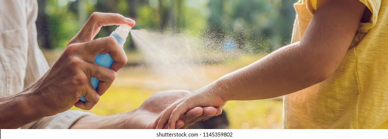 Dad And Son Use Mosquito Spray.Spraying Insect Repellent On Skin Outdoor BANNER, Long Format