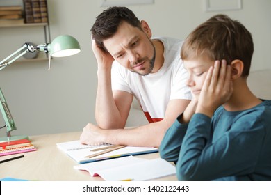 Dad Struggling To Help His Son With School Assignment At Home