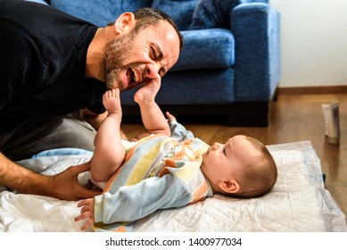 Dad Struggling With His Baby Daughter To Change Dirty Diapers Putting Faces Of Effort, Concept Of Fatherhood.