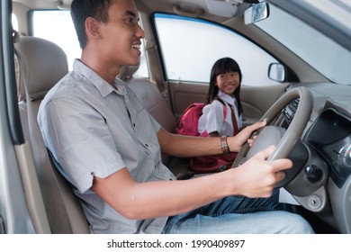 Dad Taking Her Daughter To School In The Morning By Driving A Car. Asian Primary Pupil Back To School