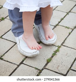 Dad To Teach Child To Walk. Walking Barefoot