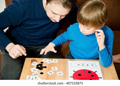 Dad teaches the child to count. Homework. - Powered by Shutterstock