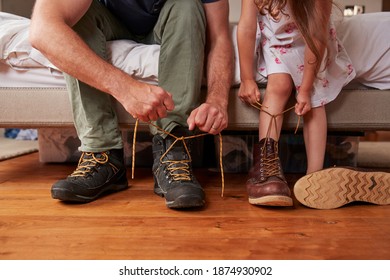 Dad teaching his daughter how to tie shoelaces, low section - Powered by Shutterstock