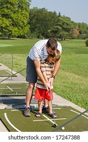 Dad Teaching Son Golf