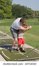 Dad Teaching Son Golf