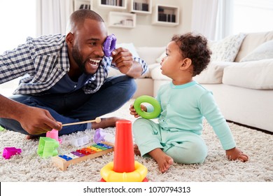 Dad And Toddler Son Having Fun Playing At Home, Close Up