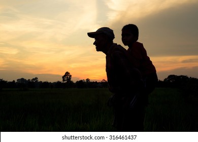 Dad took his son piggyback ride during sunset. - Powered by Shutterstock