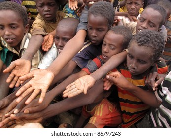DADAAB, SOMALIA-AUGUST 15: Unidentified children stretch out their hands at the Dadaab refugee camp where thousands of Somalian wait for help because of hunger on August 15, 2011, in Dadaab, Somalia.