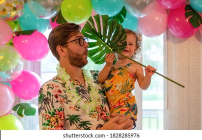 Daddy And Daughter Having Fun At A Tropical Theme Birthday Party